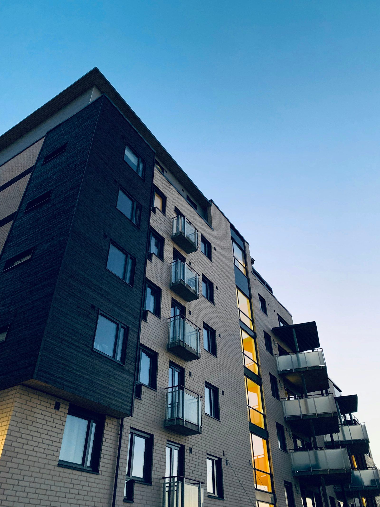 A completed Bansal Group mid-rise development at dusk.